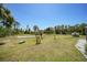 Expansive backyard featuring a bench, small trees, and open space for outdoor enjoyment at 5460 Norlander Dr, Port Charlotte, FL 33981