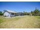 Spacious backyard with a screened patio area and lush greenery at 5460 Norlander Dr, Port Charlotte, FL 33981
