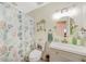 Charming bathroom featuring a patterned shower curtain, small shelf, mirror and white vanity at 5460 Norlander Dr, Port Charlotte, FL 33981
