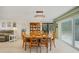 Elegant dining area featuring a chandelier, and a view into the screened in lanai at 5460 Norlander Dr, Port Charlotte, FL 33981