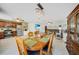 Elegant dining area featuring a chandelier, wood table, and views into the kitchen and living room at 5460 Norlander Dr, Port Charlotte, FL 33981