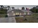 Charming single-story home featuring a well-maintained yard and an American flag waving proudly at 5460 Norlander Dr, Port Charlotte, FL 33981