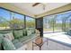 Bright Florida room boasts tile flooring, comfortable seating, and backyard views at 5460 Norlander Dr, Port Charlotte, FL 33981
