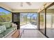 Open Florida room featuring tile floors, ceiling fan and sliding glass door to backyard at 5460 Norlander Dr, Port Charlotte, FL 33981