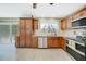 Well-equipped kitchen with stainless steel appliances, wooden cabinets, and modern backsplash at 5460 Norlander Dr, Port Charlotte, FL 33981