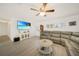 Comfortable living room with a large TV, modern flooring, and natural light at 5460 Norlander Dr, Port Charlotte, FL 33981