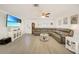 Bright living room with a large sectional sofa, TV, and beach-themed decor at 5460 Norlander Dr, Port Charlotte, FL 33981