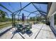 Screened patio offers outdoor dining space and overhead lighting, perfect for entertaining at 5460 Norlander Dr, Port Charlotte, FL 33981