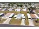 Aerial view of a well-maintained home surrounded by a lush lawn and mature trees at 6168 Partridge Ave, Englewood, FL 34224