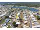 Aerial view of community with lake view, mature trees, and neatly kept homes at 6168 Partridge Ave, Englewood, FL 34224