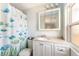 Cozy bathroom with vanity, cabinet, and fish-themed shower curtain at 6168 Partridge Ave, Englewood, FL 34224
