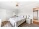 Comfortable bedroom featuring laminate floors and a doorway to an en-suite bathroom at 6168 Partridge Ave, Englewood, FL 34224