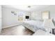 Comfortable bedroom with bright walls, laminate floors, and a large window providing plenty of natural light at 6168 Partridge Ave, Englewood, FL 34224
