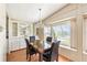 Bright dining room features display cabinets, pendant lighting, and large windows at 6168 Partridge Ave, Englewood, FL 34224