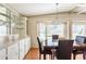 Bright dining room with display cabinets, pendant lighting, and a large window at 6168 Partridge Ave, Englewood, FL 34224