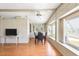 Charming dining area featuring bright windows, a ceiling fan, and a stylish dining set at 6168 Partridge Ave, Englewood, FL 34224