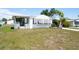 Charming single-story home with a well-maintained lawn and convenient covered parking at 6168 Partridge Ave, Englewood, FL 34224