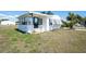 Charming exterior features black trim, lovely landscaping, and an airy sunroom at 6168 Partridge Ave, Englewood, FL 34224