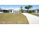 Charming home with a manicured lawn, covered parking, and a welcoming entrance at 6168 Partridge Ave, Englewood, FL 34224