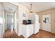 Practical kitchenette with white cabinets and appliances, complemented by laminate flooring and ample natural light at 6168 Partridge Ave, Englewood, FL 34224