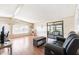 Spacious living room with laminate flooring, ceiling fan, and sliding glass doors to a screened porch at 6168 Partridge Ave, Englewood, FL 34224