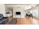 Living room with TV, sofa, open floorplan to kitchen and dining room at 6168 Partridge Ave, Englewood, FL 34224
