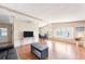 Bright living room flows to dining area, features wood floors, and has natural light at 6168 Partridge Ave, Englewood, FL 34224