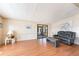 Bright living room featuring laminate flooring, neutral paint, and sliding glass doors to a screened porch at 6168 Partridge Ave, Englewood, FL 34224