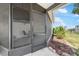 Screened in porch with furniture, screen door with view of plants and sky at 6168 Partridge Ave, Englewood, FL 34224