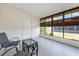 A screened-in sunroom features large windows, flooding the space with natural light and scenic views at 6168 Partridge Ave, Englewood, FL 34224