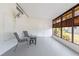 The screened-in sunroom features large windows and comfortable seating, perfect for enjoying the view at 6168 Partridge Ave, Englewood, FL 34224