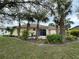 Charming backyard with tropical landscaping and a cozy red tile patio, great for entertaining at 67 Marker Rd, Rotonda West, FL 33947