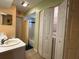 Practical bathroom design with a single sink vanity, shower and bath combination, and laundry closet at 67 Marker Rd, Rotonda West, FL 33947