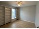 Bedroom with built-in bookshelves, hardwood floors, and ample natural light from the window at 67 Marker Rd, Rotonda West, FL 33947