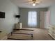 Spacious bedroom with neutral walls, plush carpet, and a window providing natural light at 67 Marker Rd, Rotonda West, FL 33947