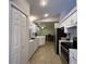 Well-lit kitchen featuring stainless steel appliances and a pass-through into the dining room at 67 Marker Rd, Rotonda West, FL 33947