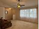 Bright living room featuring large windows, plush carpeting, and lots of natural light at 67 Marker Rd, Rotonda West, FL 33947