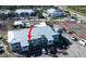 Aerial view of condo complex with tennis courts, pool, and parking at 6800 Placida Rd # 227, Englewood, FL 34224