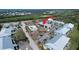 Aerial view of the condo complex with pool, tennis courts and a view of the surrounding area at 6800 Placida Rd # 227, Englewood, FL 34224