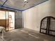 Bedroom featuring sliding door, ceiling fan, block wall, and the layout before the renovation is complete at 6800 Placida Rd # F294, Englewood, FL 34224