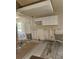 Spacious kitchen area undergoing renovations with protective flooring and exposed walls at 6800 Placida Rd # F294, Englewood, FL 34224