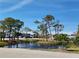 Scenic view of pond surrounded by trees and condo buildings at 6800 Placida Rd # F294, Englewood, FL 34224