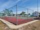 Outdoor tennis court with surrounding fence and nearby condominiums at 6800 Placida Rd # F294, Englewood, FL 34224