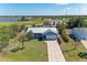 An aerial view of a single-Gathering home showcasing its manicured lawn and neighborhood at 7360 David Blvd, Port Charlotte, FL 33981