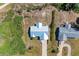 Bird's eye view of the house with a metal roof and long driveway at 7360 David Blvd, Port Charlotte, FL 33981