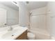 Bathroom features white tiled shower and tub, light wood vanity, and white toilet at 7360 David Blvd, Port Charlotte, FL 33981