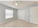 Bedroom with a ceiling fan, tile floor, a large window, and closet at 7360 David Blvd, Port Charlotte, FL 33981