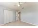 Bedroom featuring tile flooring, ceiling fan, closet with double doors, and neutral colored walls at 7360 David Blvd, Port Charlotte, FL 33981