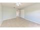 Bedroom with tile floors, ceiling fan, closet and neutral paint color at 7360 David Blvd, Port Charlotte, FL 33981
