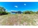 Charming single-story home with a metal roof and bright blue exterior paint at 7360 David Blvd, Port Charlotte, FL 33981